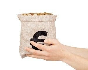 hands holding a bag of coins isolated on white